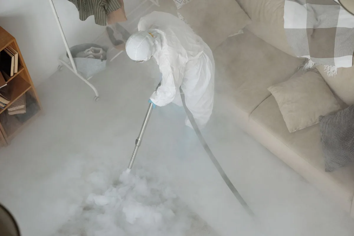 Biohazard cleanup technician in protective equipment, University Park Estates, Long Beach, CA